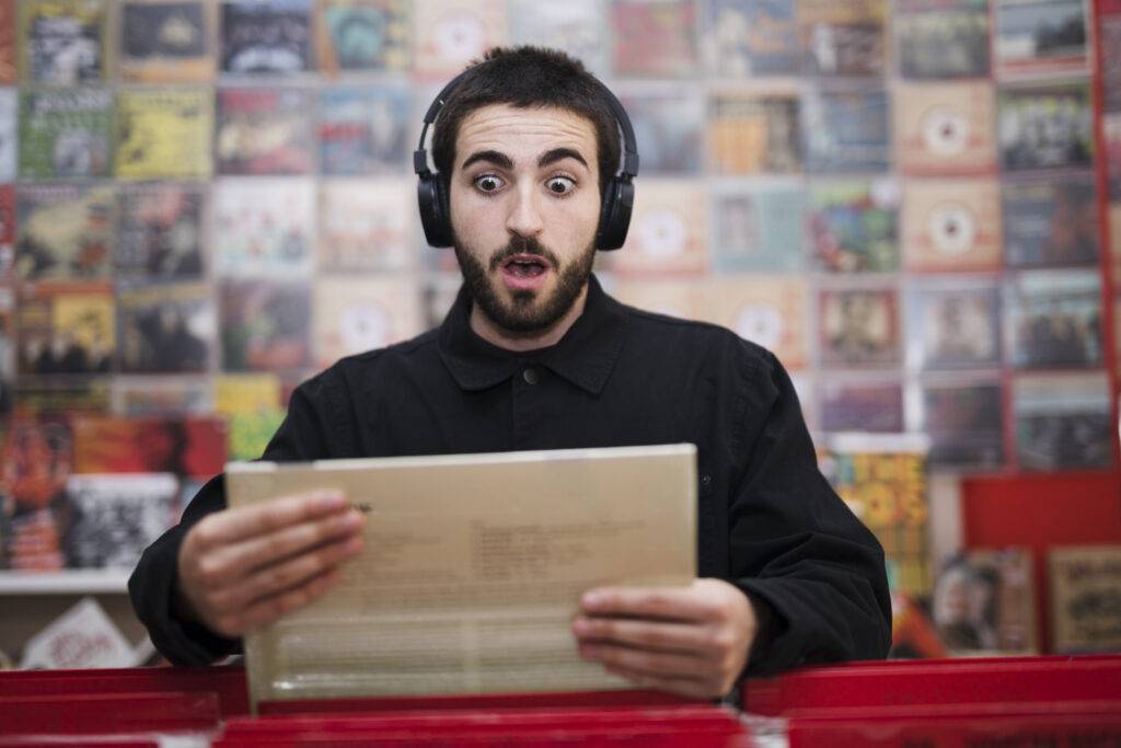 medium shot young man listening music vinyl store
